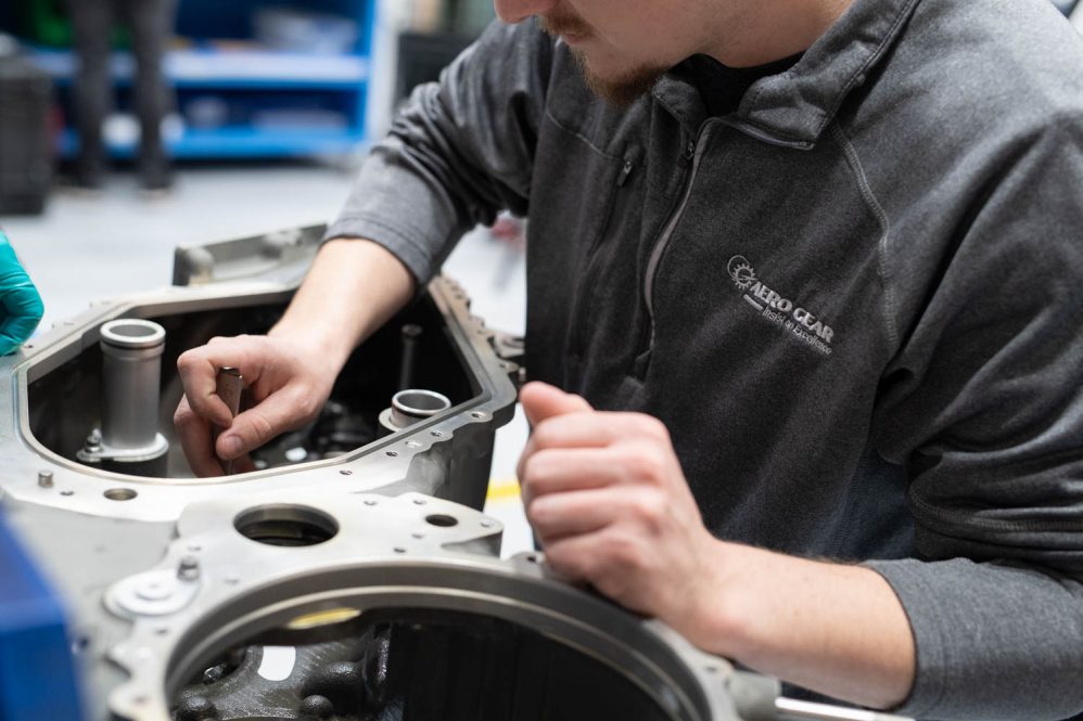 An Aero Gear employee works on gearbox assembly
